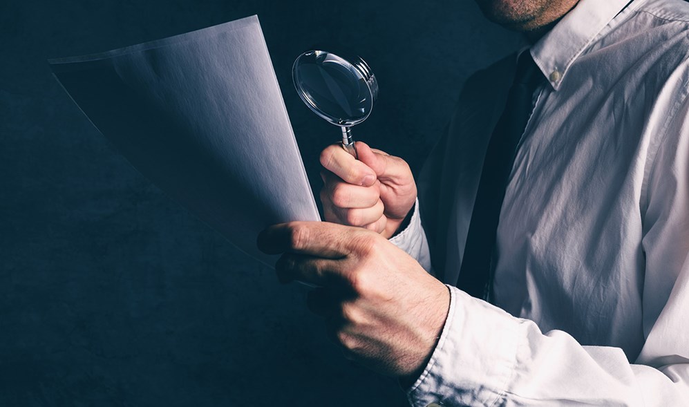 Tax Inspector Looking over Financials