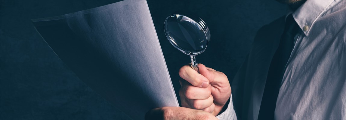 Tax Inspector Looking over Financials
