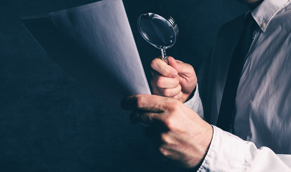 Tax Inspector Looking over Financials